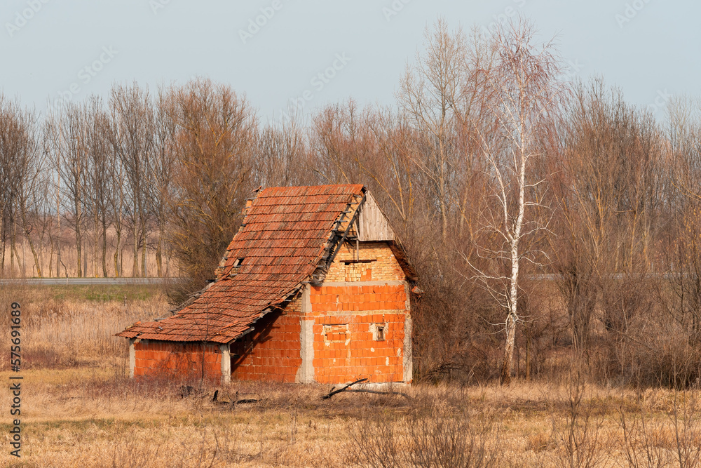 Old abandoned house in meadow