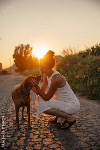 woman and dog in the sunset photo