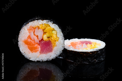 Japanese cuisine maki sushi rolls with tuna, salmon, shrimp and mango.