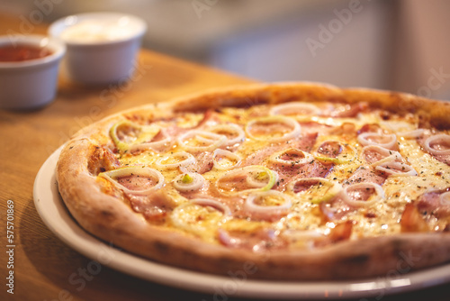 Oven pizza.  Pizza with toppings. Pizza with corn. Photo of the pizza. Pizza on a wooden table. 