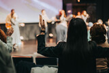 Rising in Faith: A Woman's Worshipful Gesture at Church