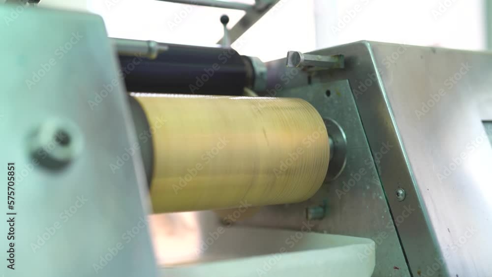 Someone injecting out white thick liquid on a machine in paint factory Someone injecting out white thick liquid on a machine in paint factory