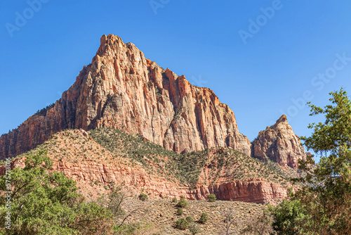 Red rock canyon and mesa in the arid desert landscape environment of Zion National Park Utah with a clear cloudless blue sky. 