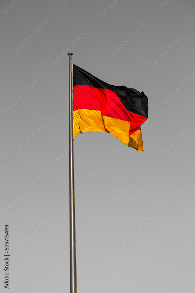 German flag on a flagpole against the blue sky German flag on a flagpole against the blue sky
