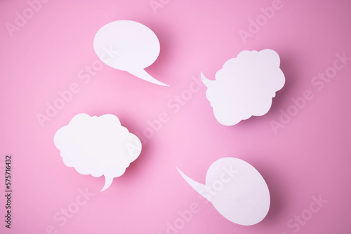 Paper templates in the form of clouds and bubbles for messages on a pink background. © Sofya