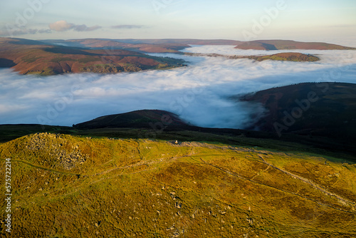 Aerial view of a mountain peak above a sea of fog in a temperature inversion  Sugar Loaf  Brecon Beacons 