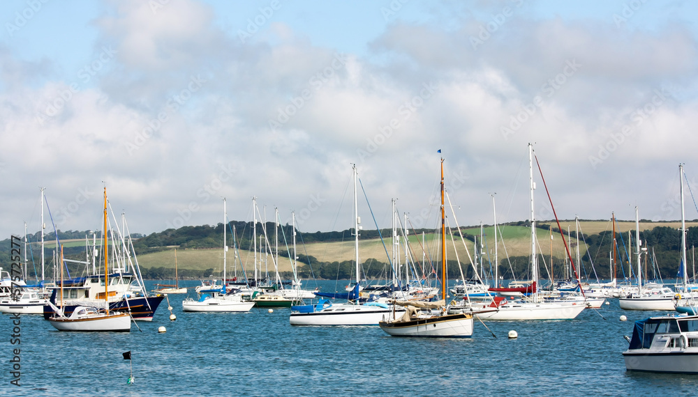 Sail boats, leisure boats and yachts moored in the Camel Estuary, Cornwall on a bright and sunny day