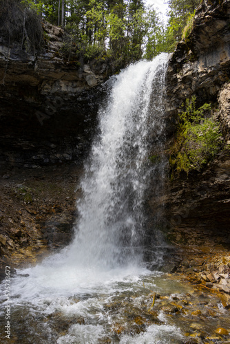 looking up at cascading waterfall in the forest