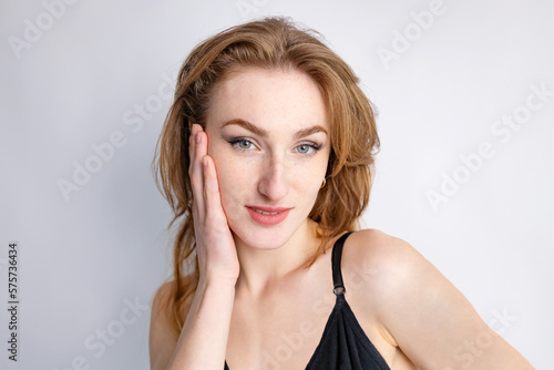 Young pretty woman, tenderly smiling female model close-up portrait isolated over pastel studio background. Perfect smooth skin, body care. Concept of beauty, skin care, naturality, health, ad