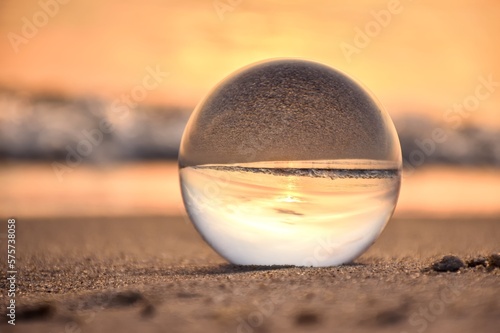 Abstract holiday seaside idea. Sea landscape held in a glass ball with a blurred background.  Photo in shallow depth of field.