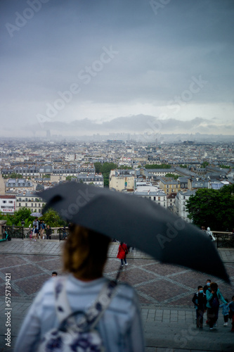 Parisian cityscape, with typical Parisian architecture and landmarks like the sa creu coeur and the Eiffel Tower can be seen. The picture was taken near the square pigalle.