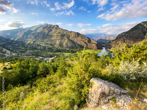 Beautiful view of the valley in the mountains with a river on a sunny summer day. Dagestan