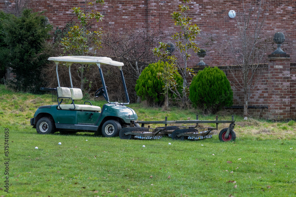 Golf ball picker cart at the driving range Golf ball picker cart at the driving range