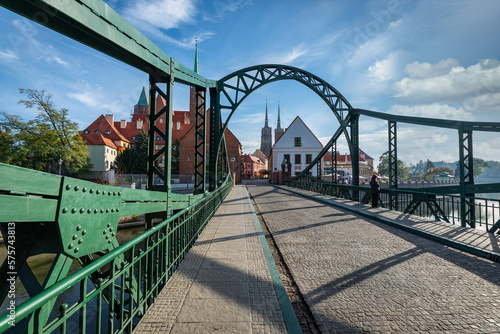 Tumski bridge in Worclaw detail shot with several buildings and church in the background 