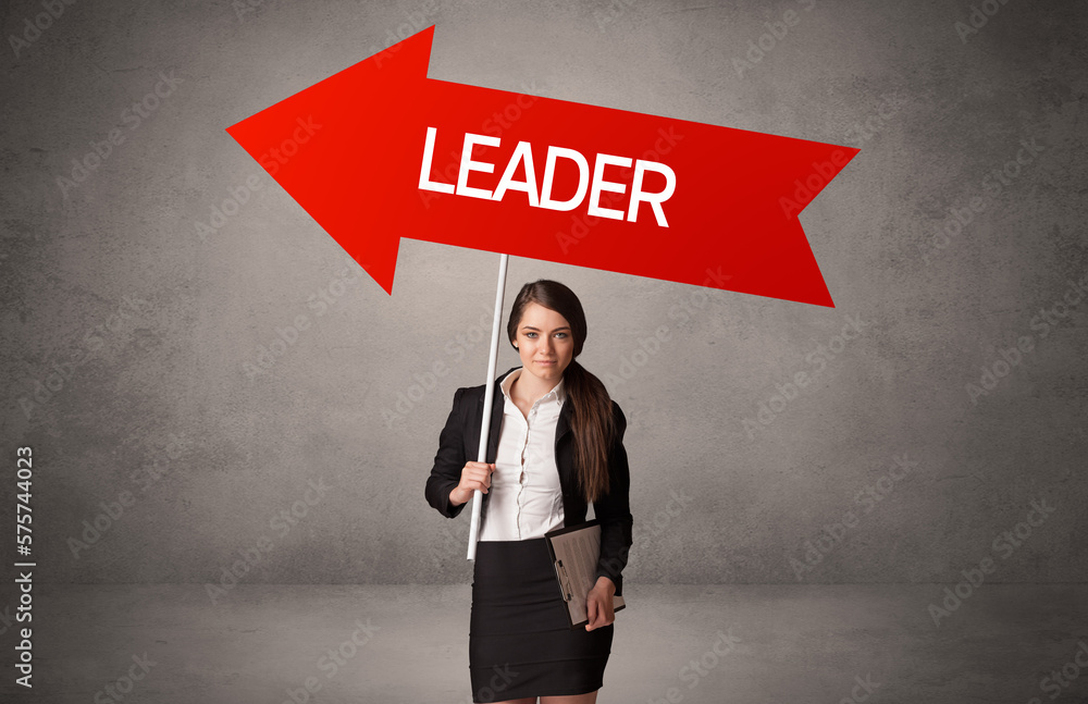 Young business person in casual holding road sign Young business person in casual holding road sign