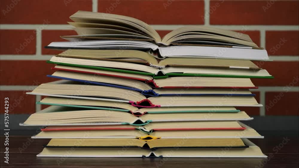 Pile of open books increases and decreases. Stop motion animation Pile of open books increases and decreases. Stop motion animation