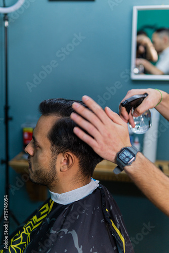 Styling straight men's hair in barber shop, with water