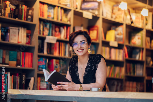 Woman reading a book while relaxing in the cafe or a bookstore