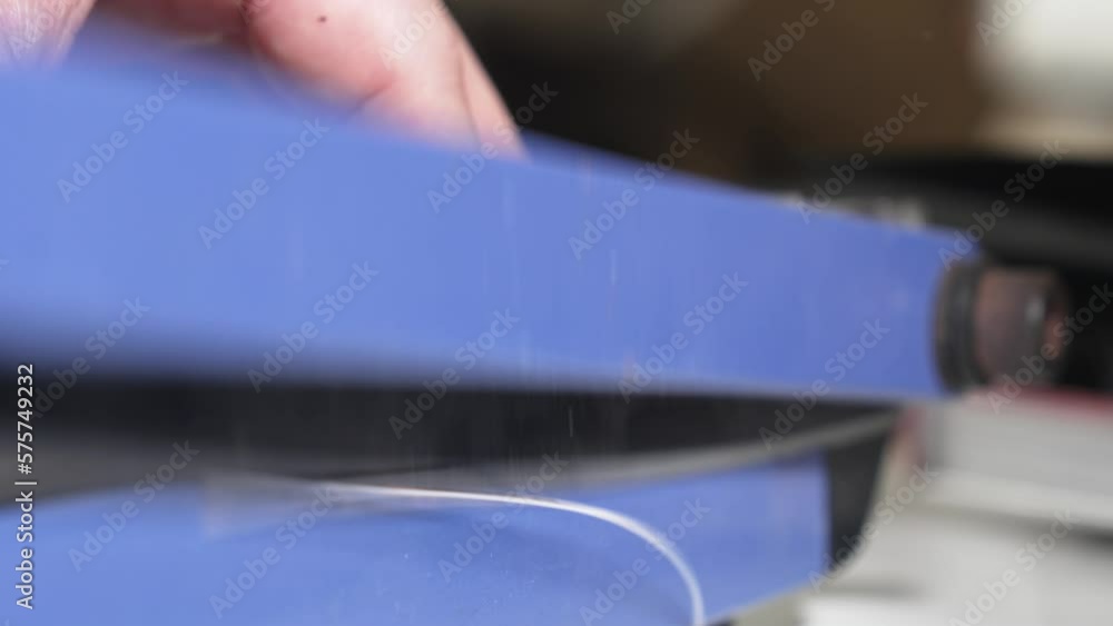 narrow depth of field. Men's hands cut photos on the cutter. narrow depth of field. Men's hands cut photos on the cutter.
