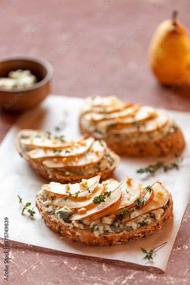 Roquefort french cheese and sliced peaches toasts on a square plate Roquefort french cheese and sliced peaches toasts on a square plate