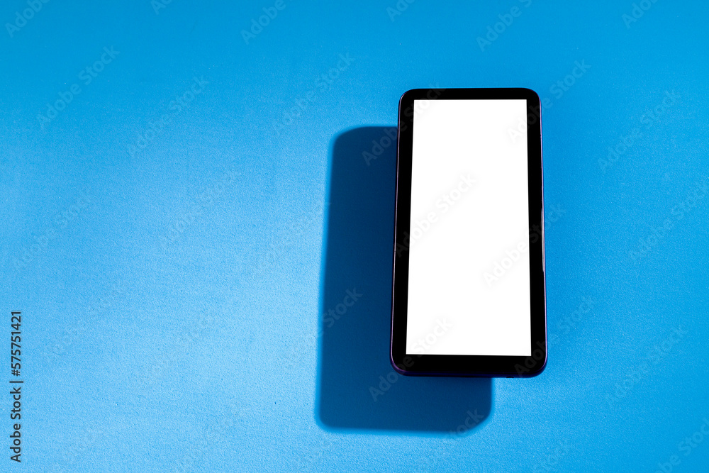 Smartphone with white screen on top of blue table. Cell phone concept. White screen concept. png Smartphone with white screen on top of blue table. Cell phone concept. White screen concept. png