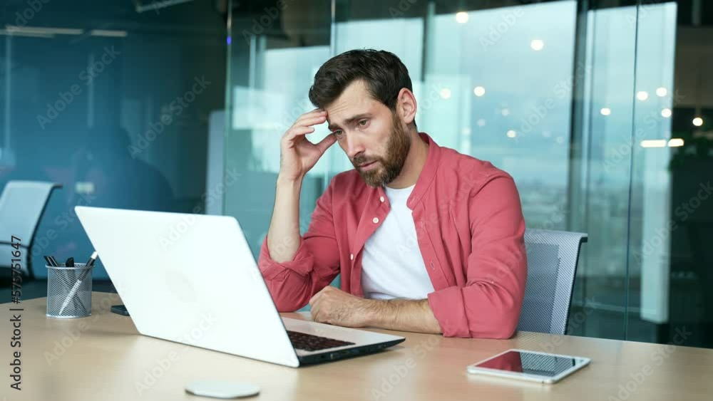 Worried stressed mature business man at desk in modern business centre feeling bad about financial crisis problem with deal indoors Depressed sad employee despairs about project failure at workplace Worried stressed mature business man at desk in modern business centre feeling bad about financial crisis problem with deal indoors Depressed sad employee despairs about project failure at workplace