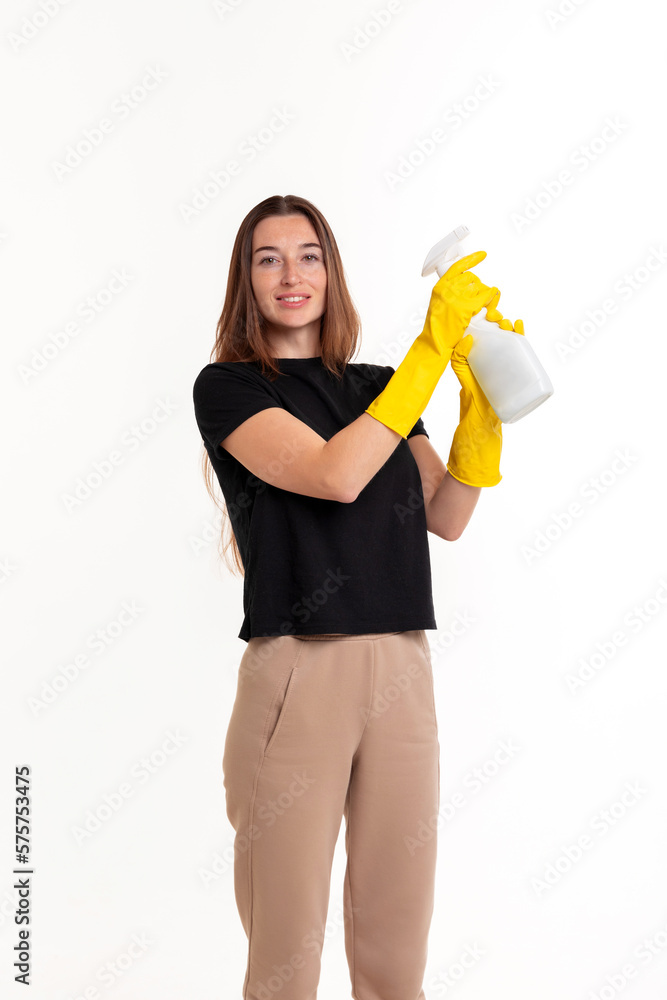 Cheerful young woman with a sprayer in her hands. The concept of cleanliness or cleaning company advertising.. Cheerful young woman with a sprayer in her hands. The concept of cleanliness or cleaning company advertising..
