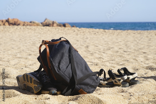 backpack, shoes and sandals lie on the beach, vacation, travel, discover