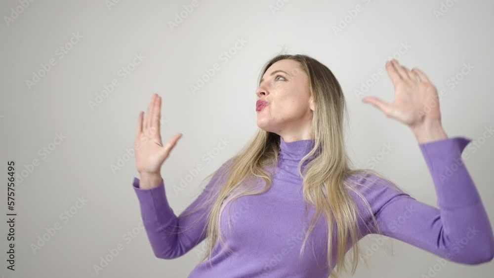 Young blonde woman smiling confident dancing over isolated white background Young blonde woman smiling confident dancing over isolated white background