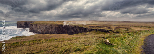 Panorama of water falling from a cliff of Kilkee and blown back by strong ocean wind. Stunning nature scene in county Clare  Ireland. Irish nature landscape. Popular travel and tourist area.
