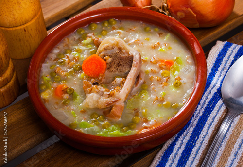 Lamb's soup cooked with pearl barley, green peas and cabbage, served in bowl