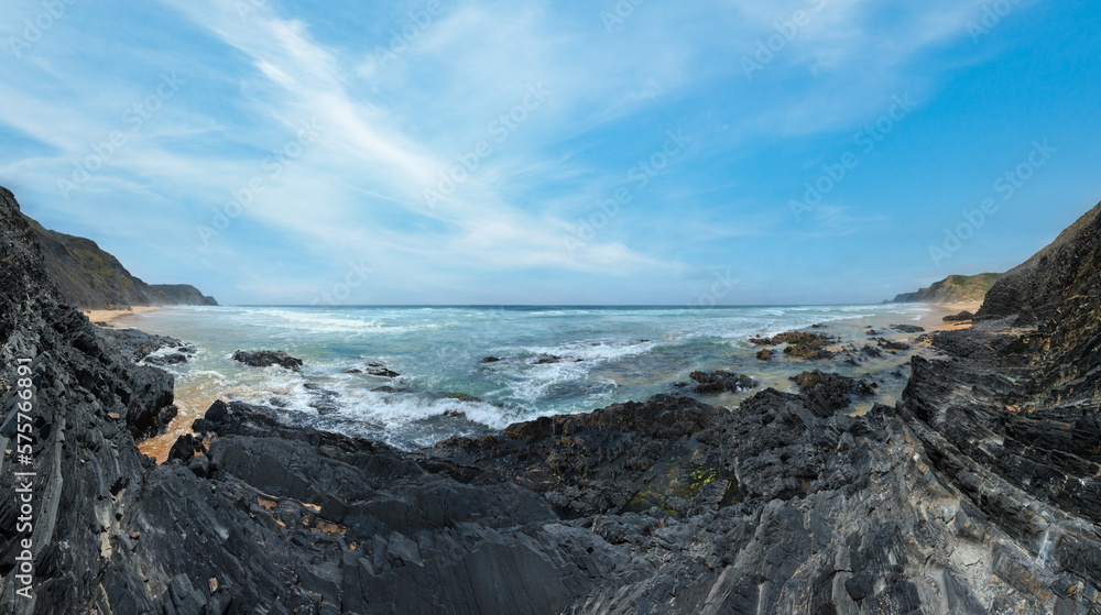 Storm on Castelejo beach with black schist stone cliffs and yelloy sand (Algarve, Portugal).