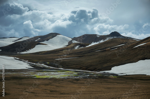 Incredible clouds flow over volcano mountains. Landmannalaugar, Iceland