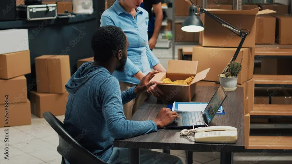 Team of startup partners doing quality control on products from storage room, checking cardboard packages of stock. Young entrepreneurs preparing goods in boxes, distribution orders. Team of startup partners doing quality control on products from storage room, checking cardboard packages of stock. Young entrepreneurs preparing goods in boxes, distribution orders.