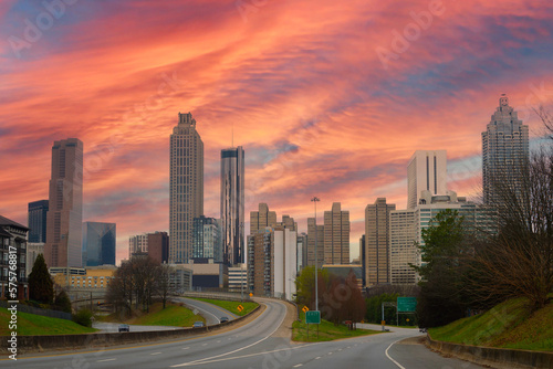 Atlanta City skyline with skyscrapers  buildings  and sunset clouds over the highway in the Capital of the U.S. State of Georgia