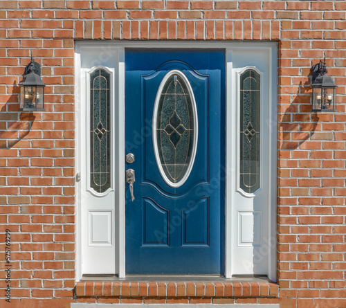 Foto Close up view of elegant blue wooden door with oval stained window, with white s
