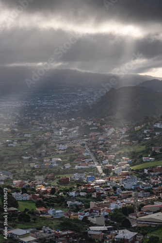 Beautiful city escape of ray of light after storm illuminating city in tenerife, canarias, spain