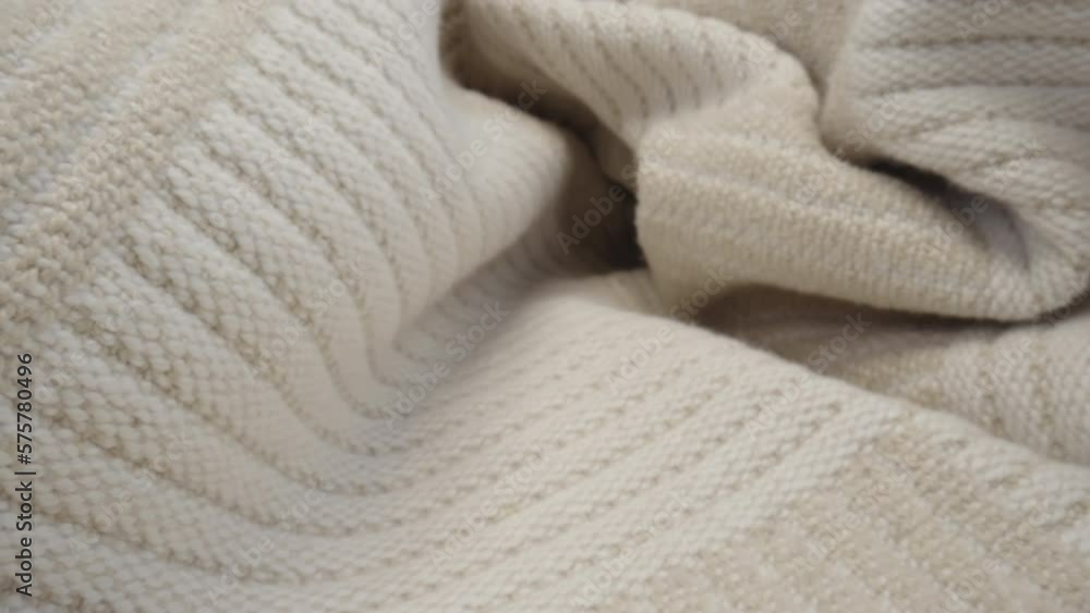 Macro shot of patterned wool fabric. Slider dolly close-up plaid knitted textile beige color texture. Laowa probe lens camera glides over detailed knit cover material Macro shot of patterned wool fabric. Slider dolly close-up plaid knitted textile beige color texture. Laowa probe lens camera glides over detailed knit cover material