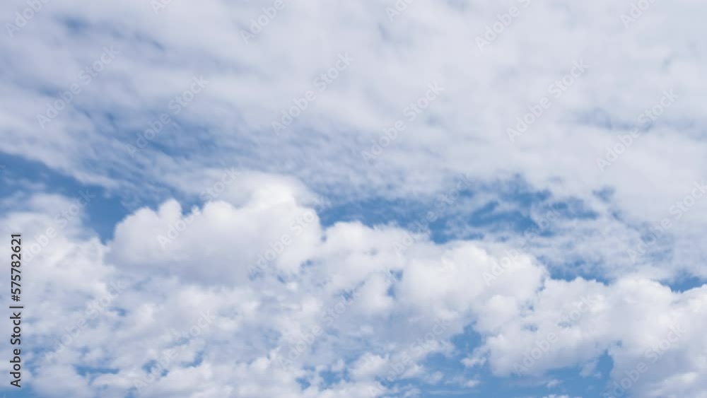 Lots of clouds moving across the blue sky. Lots of clouds moving across the blue sky.
