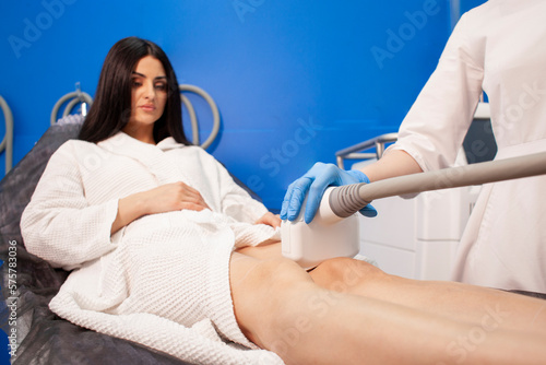 coolsculpting procedure in cosmetology clinic, doctor cosmetologist makes procedure for removing fat
