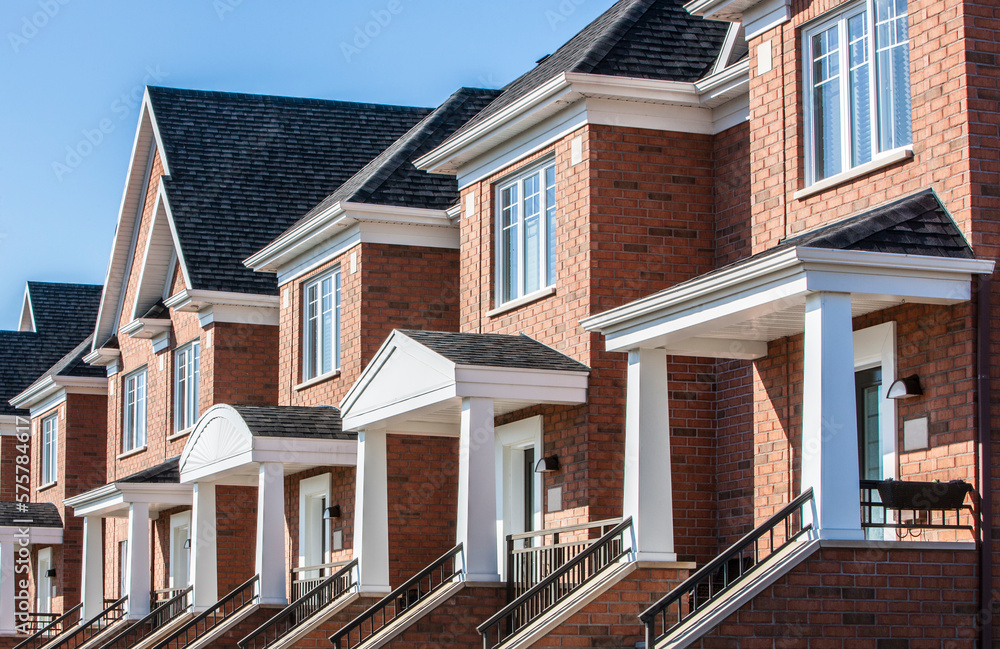 Row of red brick luxury townhouses in residential district.