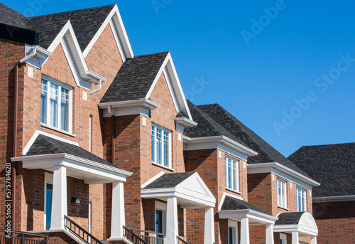 Row of red brick luxury townhouses in residential district.