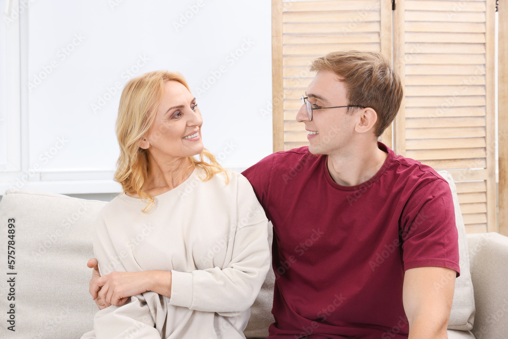 Mother and son spending time together on sofa at home. Family bonding Mother and son spending time together on sofa at home. Family bonding