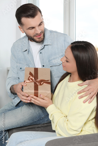 Lovely couple with beautiful gift at home