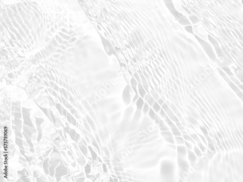 Defocus blurred transparent white colored clear calm water surface texture with splashes and bubbles. Trendy abstract nature background. Water waves in sunlight with copy space. White water shine