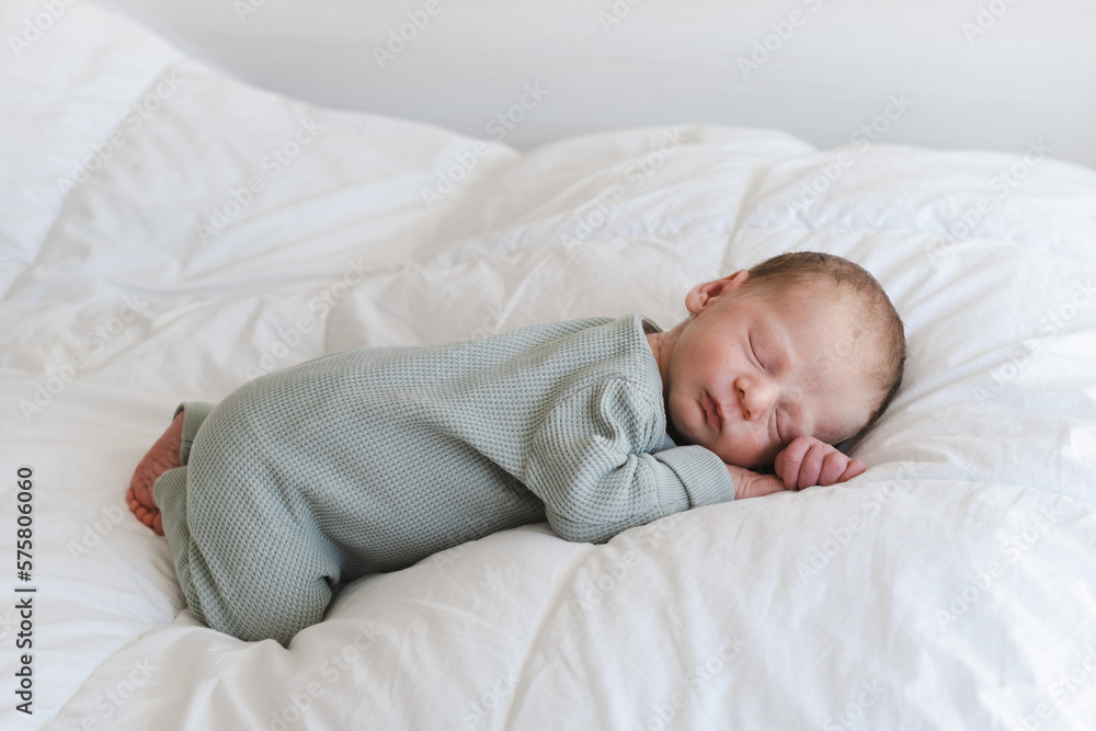 Cute caucasian several days old newborn sleeping on stomach on white blanket at home.Adorable,calm, innocent baby indoors.Copy space. Half body shot.Minimalism,lifestyle, child sweet dreams. Cute caucasian several days old newborn sleeping on stomach on white blanket at home.Adorable,calm, innocent baby indoors.Copy space. Half body shot.Minimalism,lifestyle, child sweet dreams.