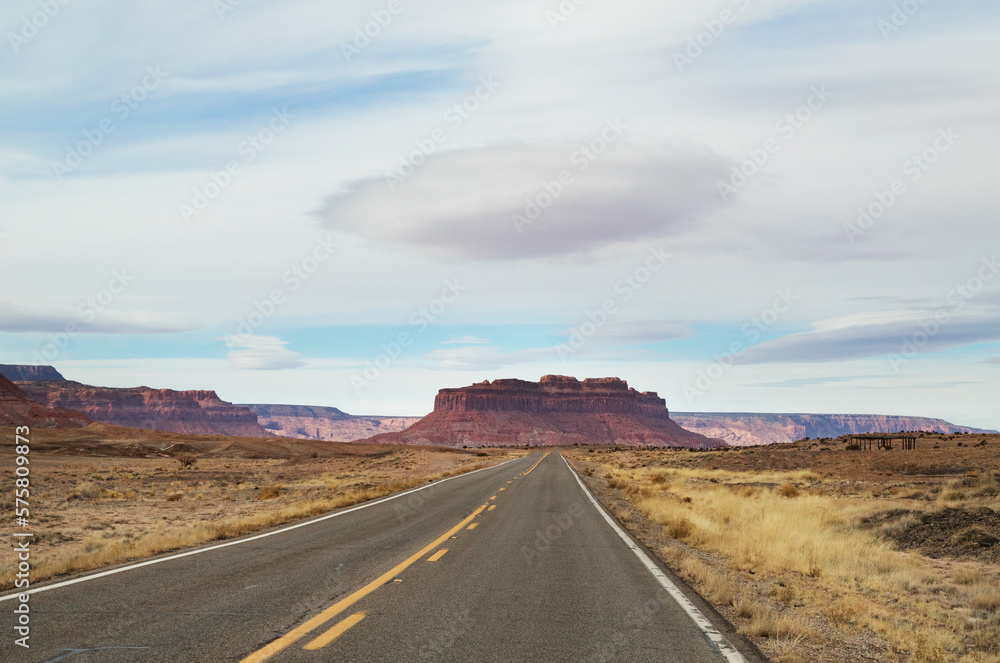 the road in the desert to the mountains with dramatic cloud