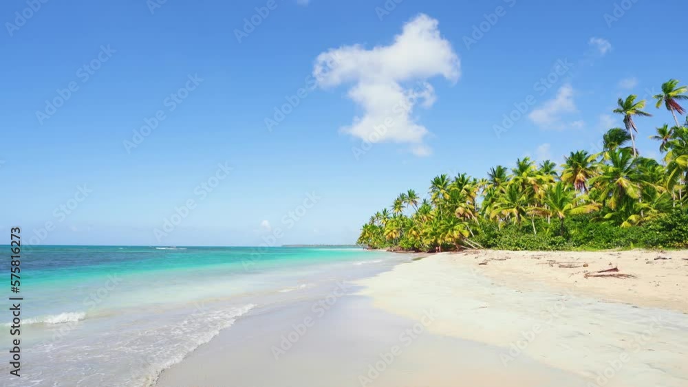 An easy walk along the Maldives isolated wild beach with palm sand and blue ocean. Clear waves on white sand. Summer tropical day. Paradise on earth. Concept of travel and vacation on the sea coast. An easy walk along the Maldives isolated wild beach with palm sand and blue ocean. Clear waves on white sand. Summer tropical day. Paradise on earth. Concept of travel and vacation on the sea coast.