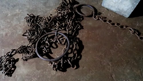 Chains on the floor in an african slave chamber of the Old Slave Market in Zanzibar. Human trafficking abolition photo