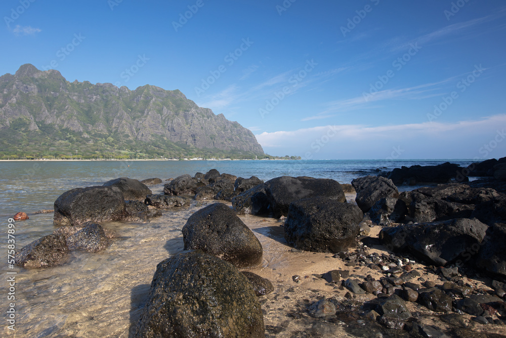 Lava rock beach on Mokolii Island [also known as Chinamans Hat] looking ...